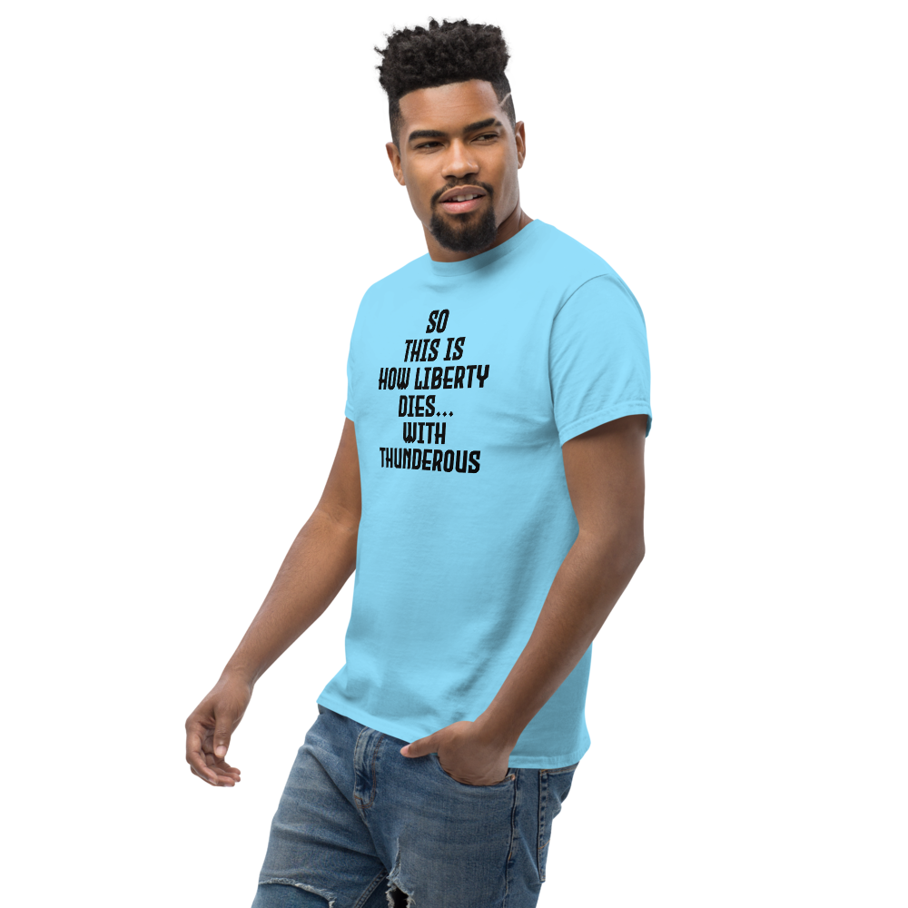 "So this is how liberty dies… with thunderous applause" printed on a sky unisex classic tee worn by a male