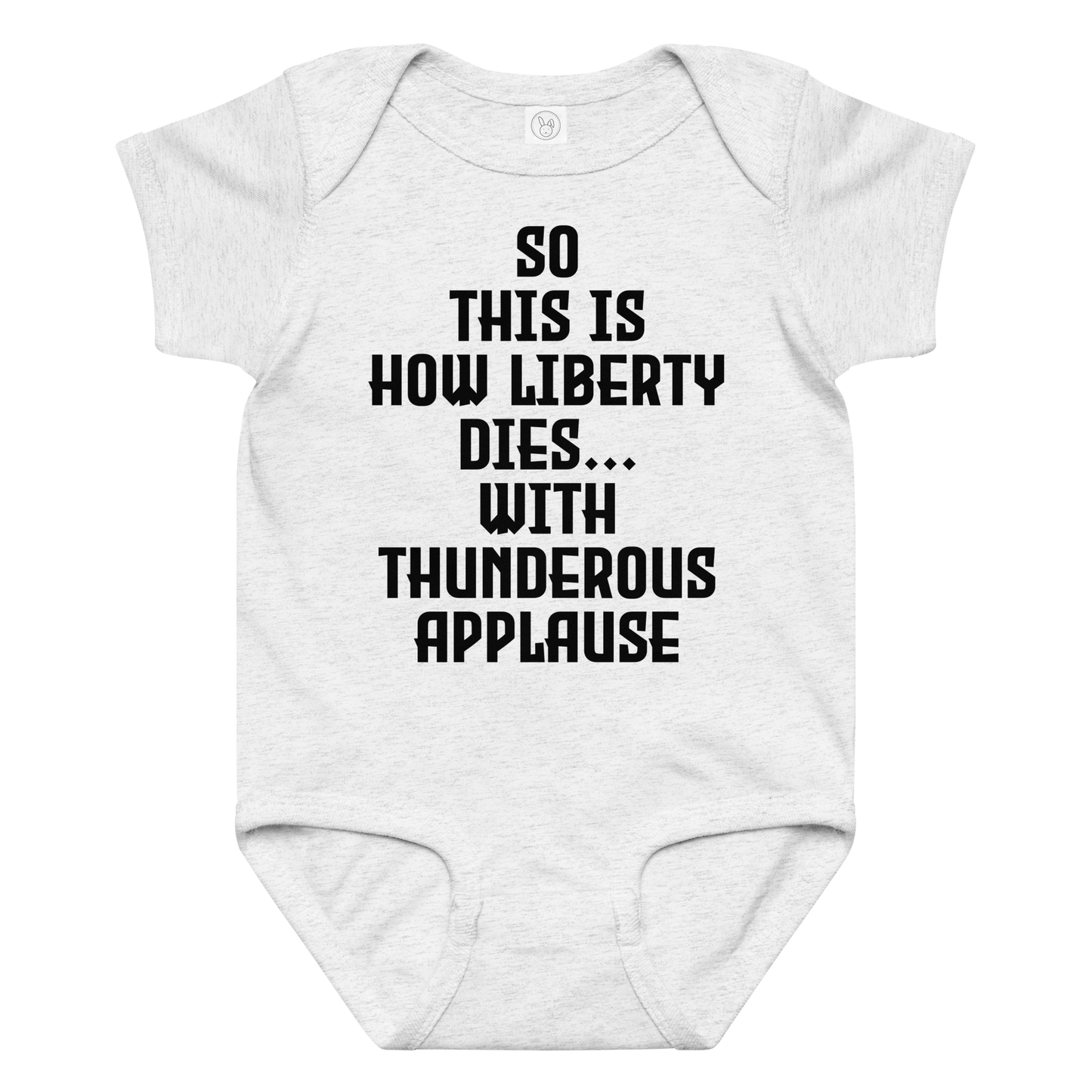 "So this is how liberty dies… with thunderous applause" printed on a ash baby jersey bodysuit laying on a flat surface amongst other clothes