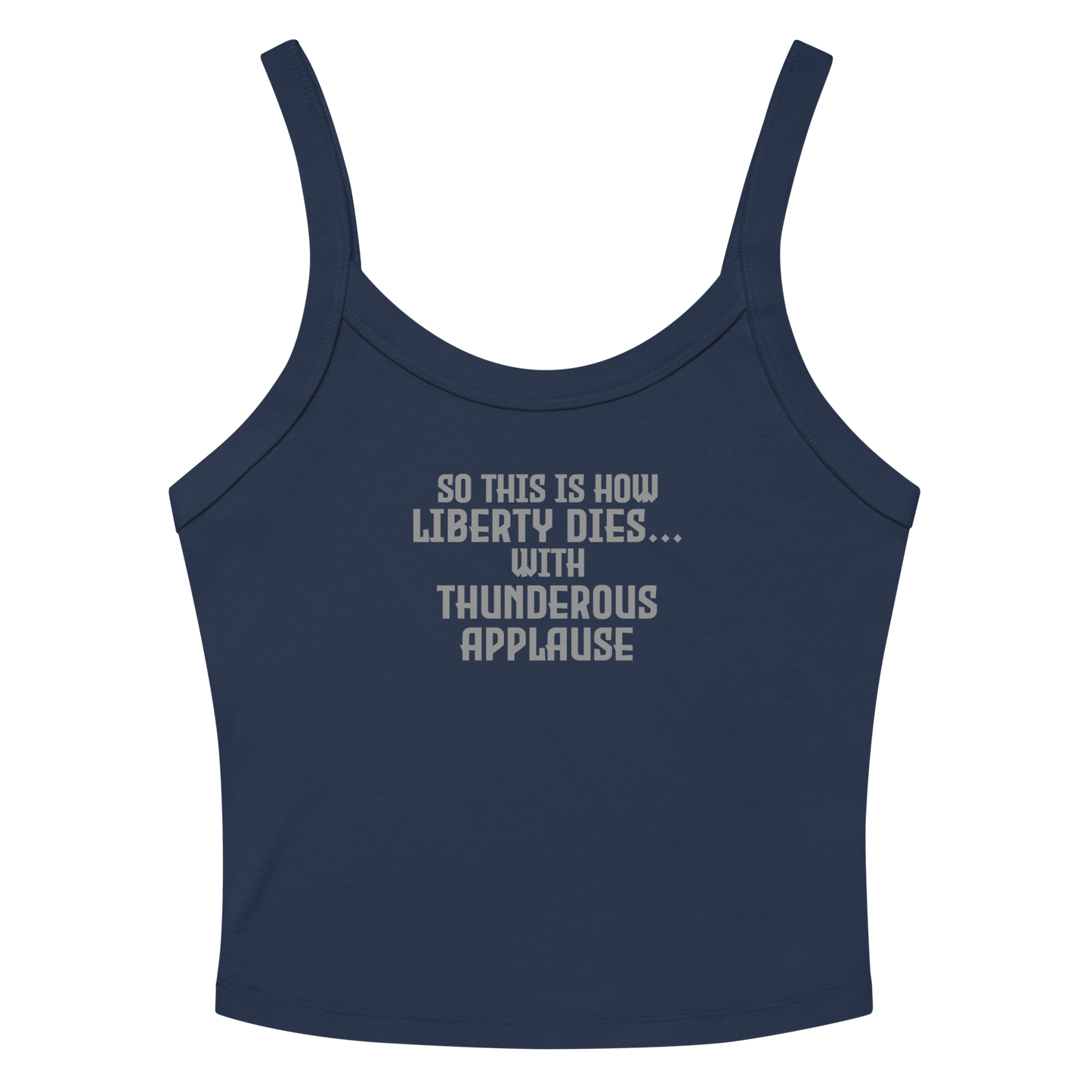 "So this is how liberty dies… with thunderous applause" printed on a solid navy blend women's micro-rib tanktop laying on a flat surface amongst sunglasses and shorts