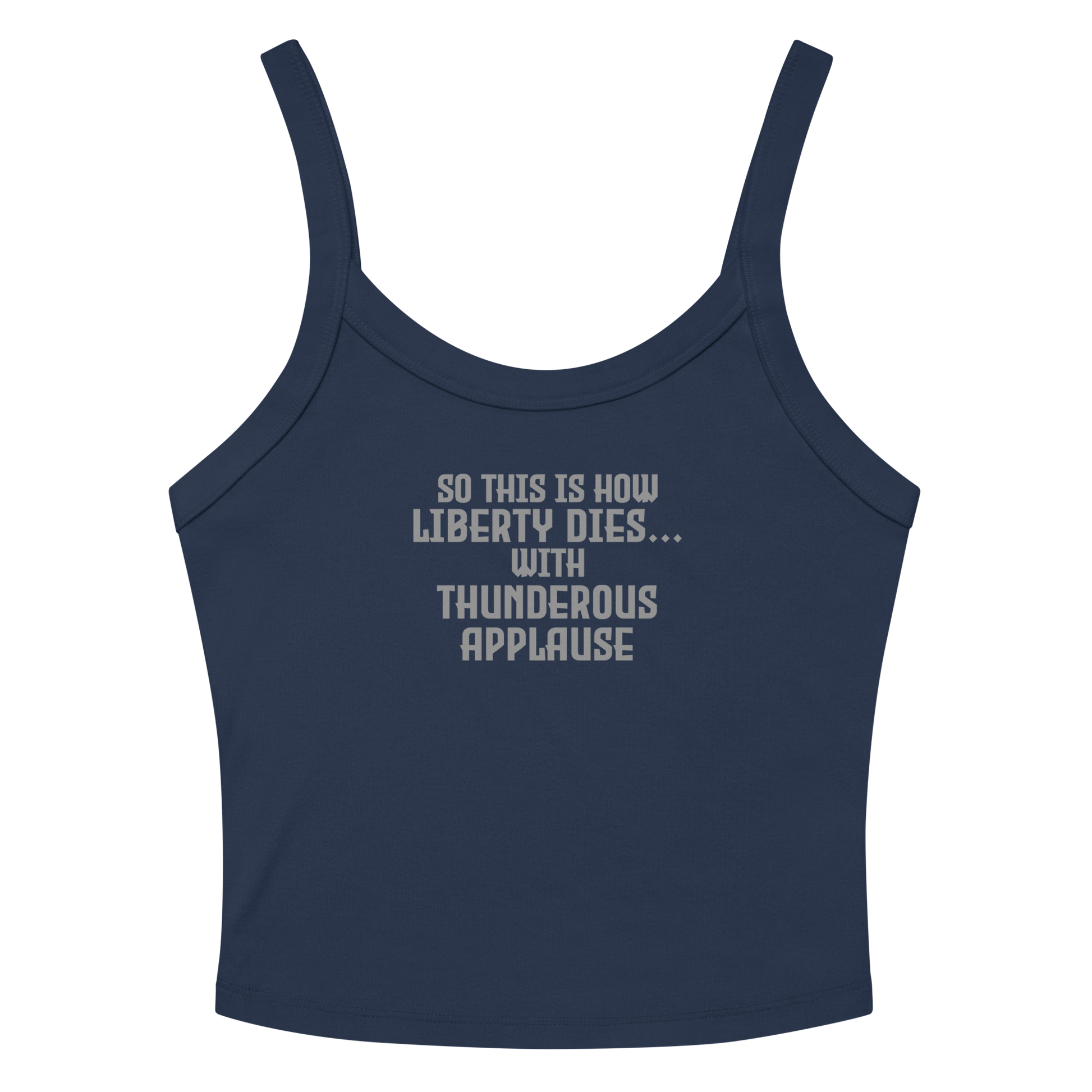 "So this is how liberty dies… with thunderous applause" printed on a solid navy blend women's micro-rib tanktop laying on a flat surface amongst sunglasses and shorts