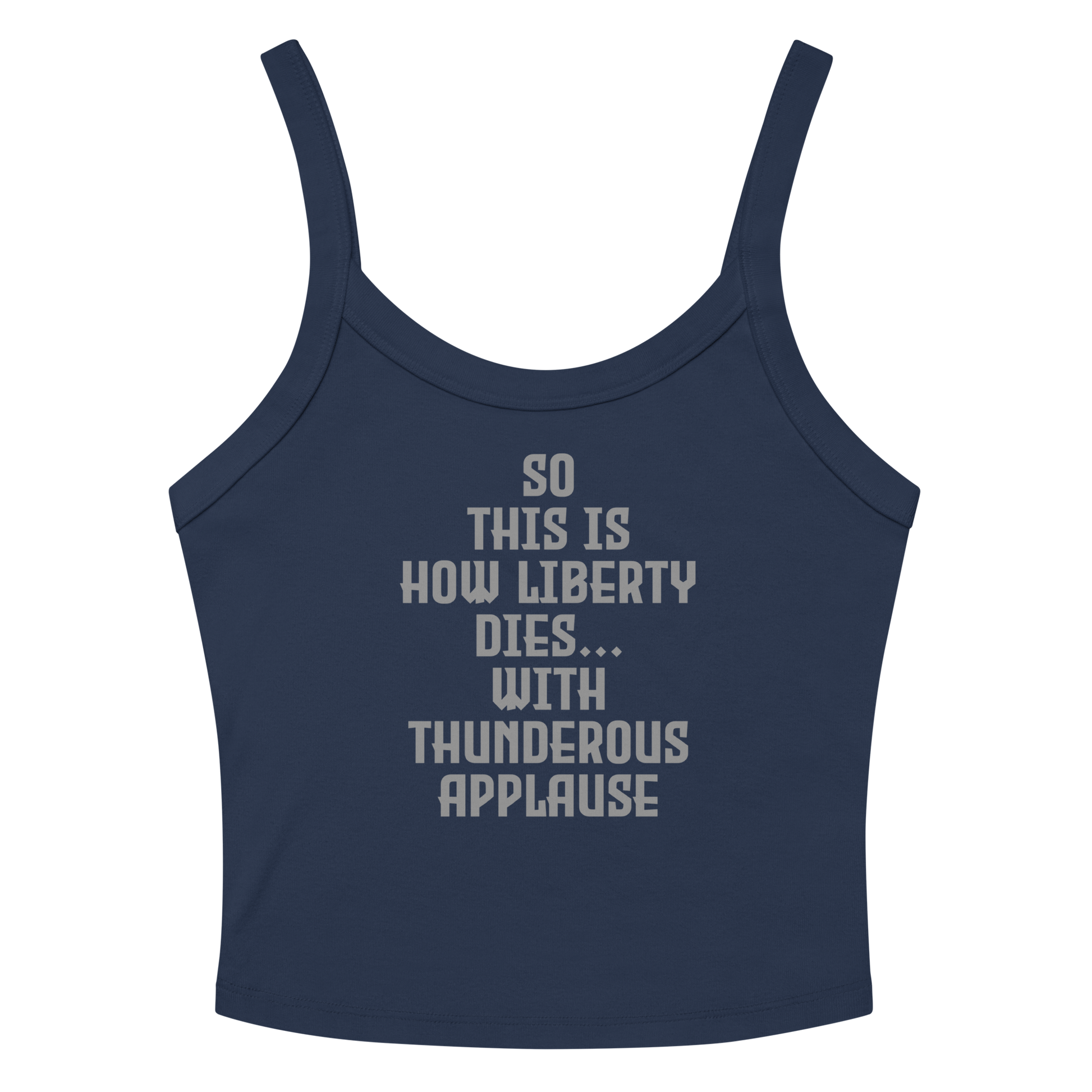 "So this is how liberty dies… with thunderous applause" printed on a solid navy blend women's micro-rib tanktop laying on a flat surface amongst sunglasses and shorts