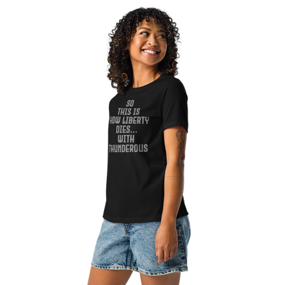 "So this is how liberty dies… with thunderous applause" printed on a black women's relaxed t-shirt worn by a female