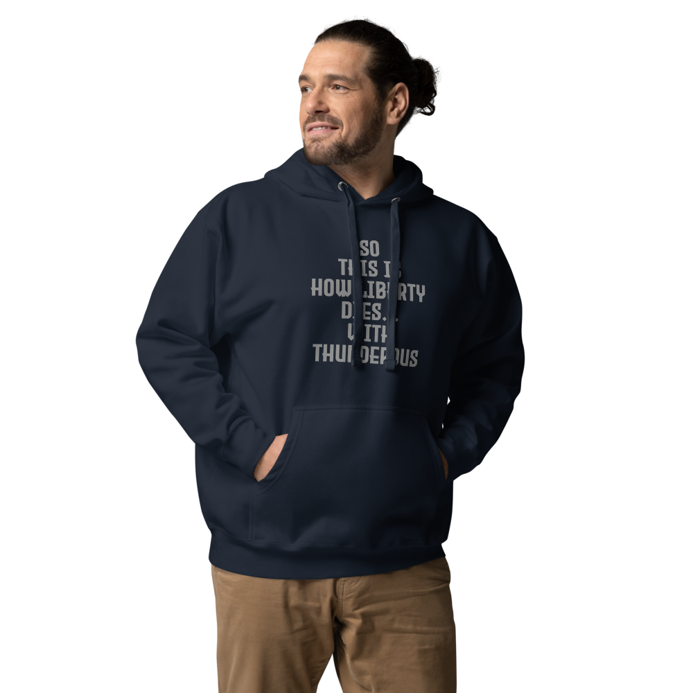 "So this is how liberty dies… with thunderous applause" printed on a navy blazer unisex hoodie worn by a male