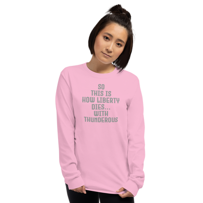 "So this is how liberty dies… with thunderous applause" printed on a light pink men's long sleeve shirt worn by a female