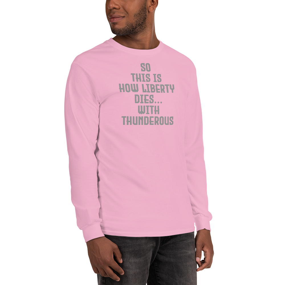 "So this is how liberty dies… with thunderous applause" printed on a light pink men's long sleeve shirt worn by a male
