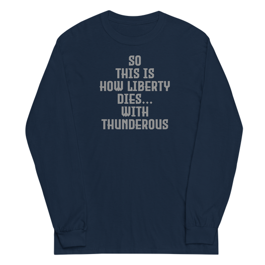 "So this is how liberty dies… with thunderous applause" printed on a navy men's long sleeve shirt laying on a flat surface