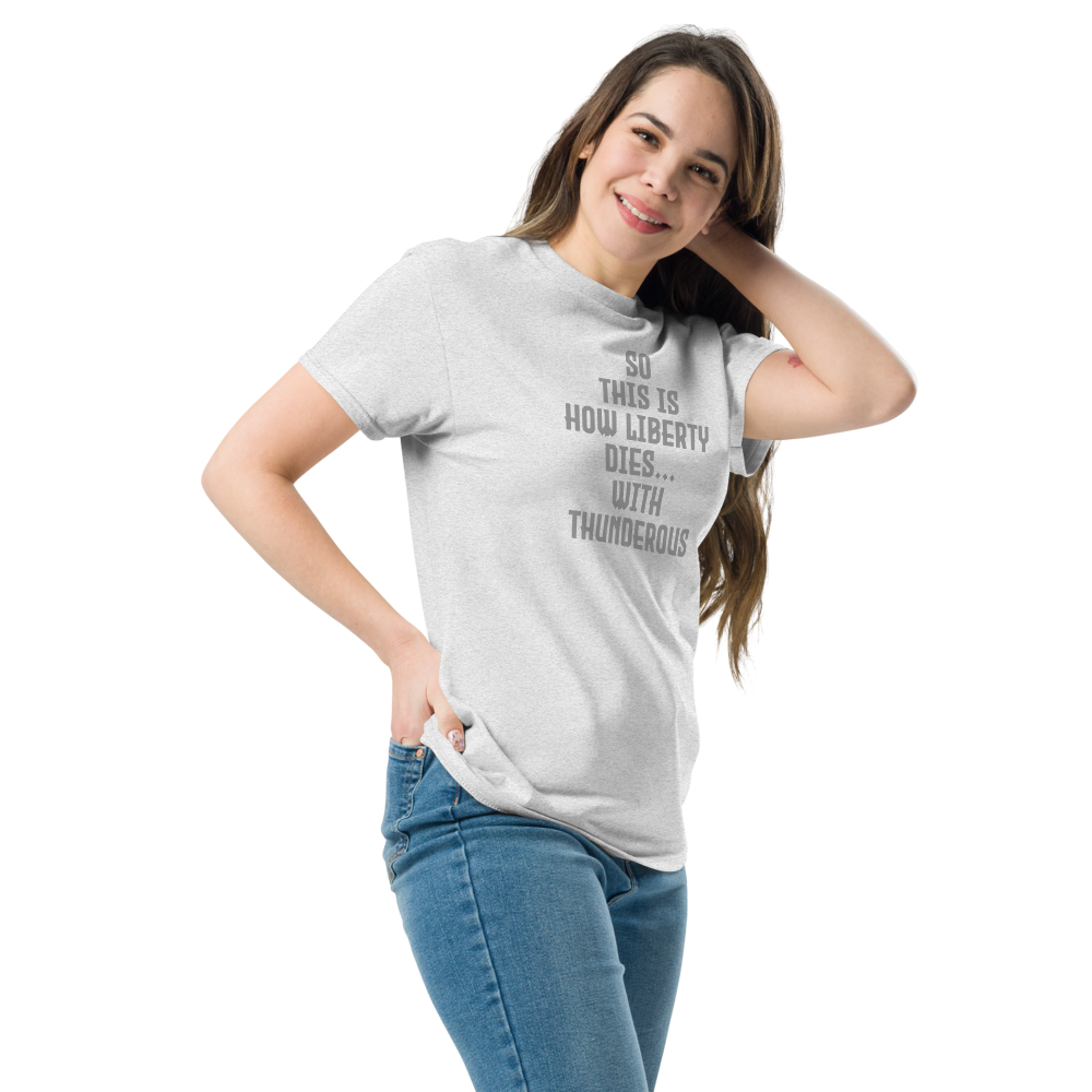 "So this is how liberty dies… with thunderous applause" printed on a ash unisex classic tee worn by a female