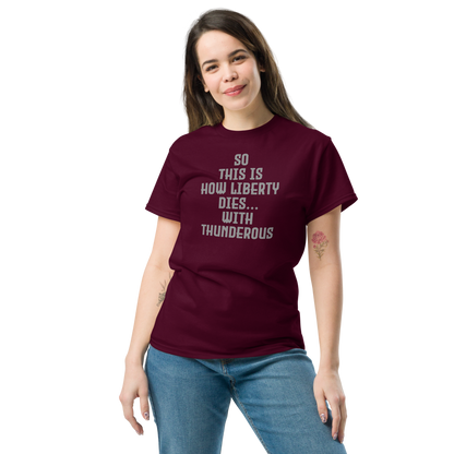 "So this is how liberty dies… with thunderous applause" printed on a maroon unisex classic tee worn by a female
