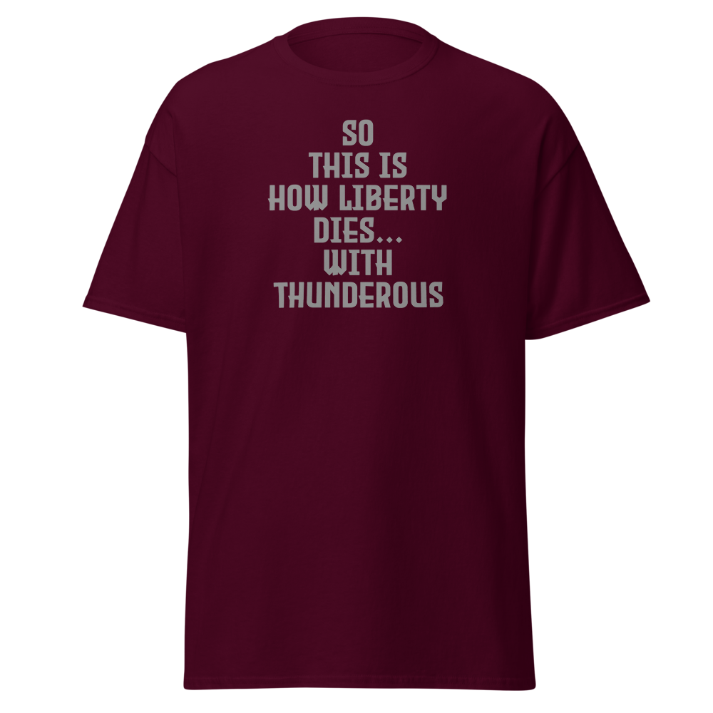 "So this is how liberty dies… with thunderous applause" printed on a maroon on an invisible body