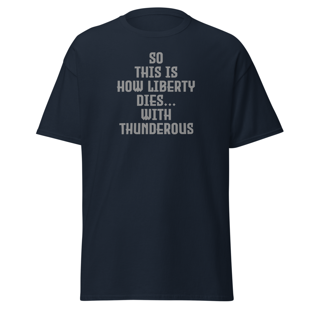 "So this is how liberty dies… with thunderous applause" printed on a navy unisex classic tee laying on a flat surface