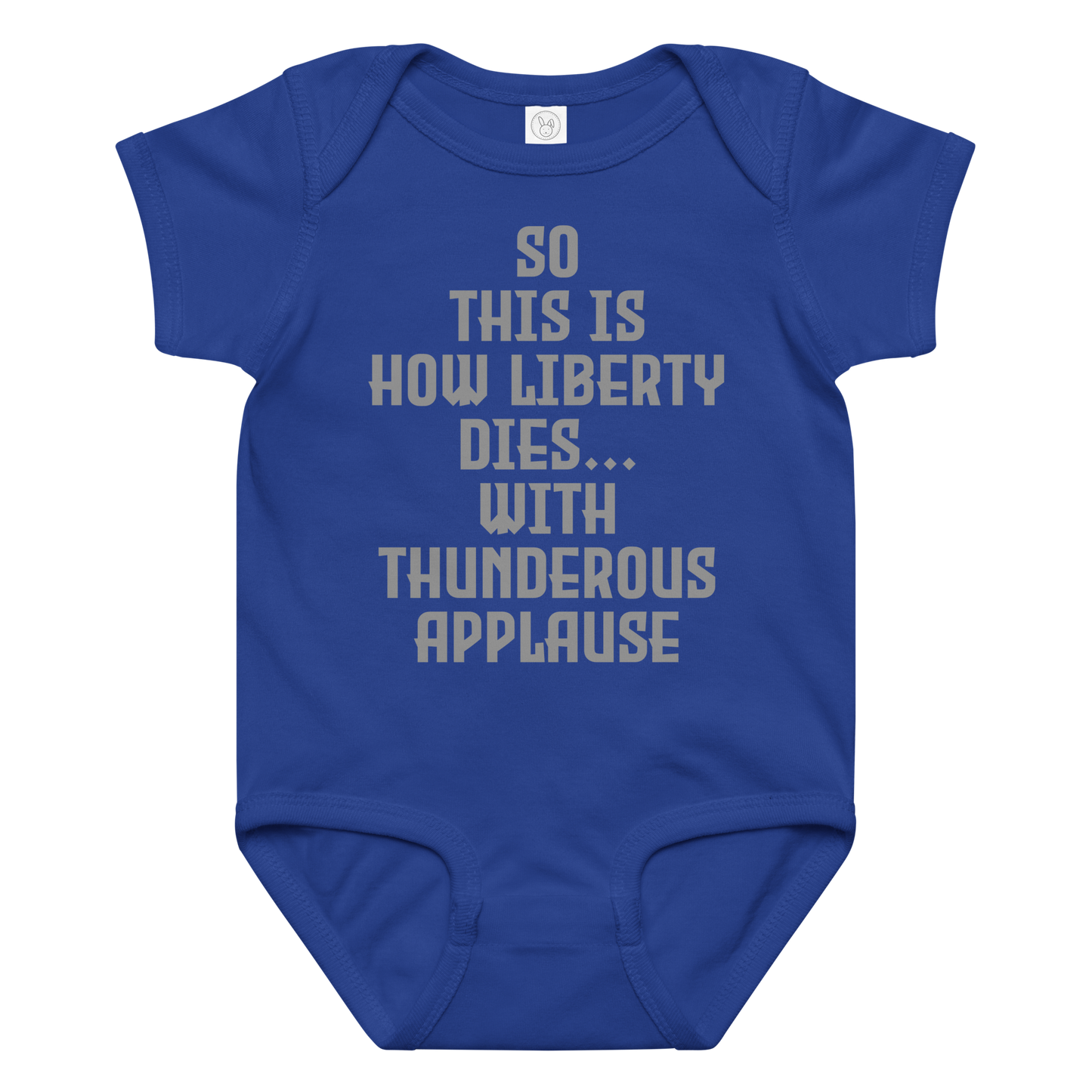 "So this is how liberty dies… with thunderous applause" printed on a royal baby jersey bodysuit laying on a flat surface amongst other clothes