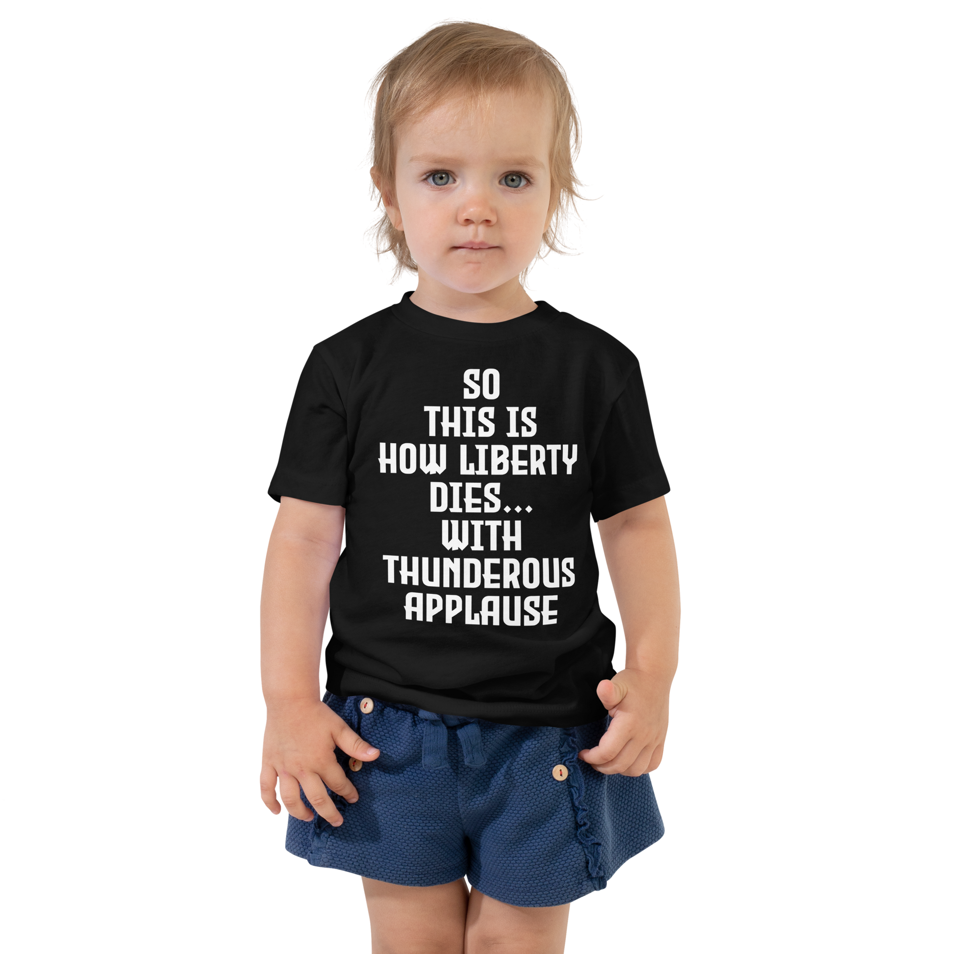"So this is how liberty dies… with thunderous applause" printed on a black toddler short sleeve tee worn by a female
