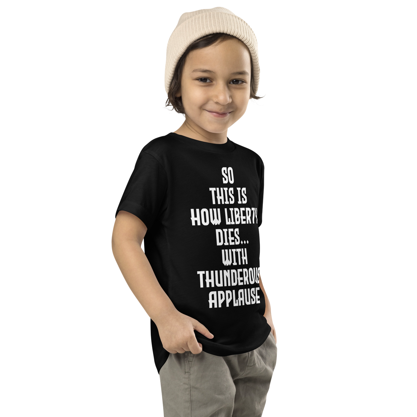 "So this is how liberty dies… with thunderous applause" printed on a black toddler short sleeve tee worn by a male who is also wearing a knit cap