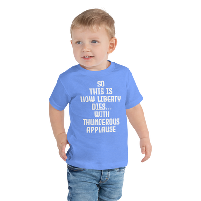 "So this is how liberty dies… with thunderous applause" printed on a heather columbia blue toddler short sleeve tee worn by a male