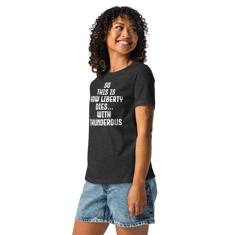 "So this is how liberty dies… with thunderous applause" printed on a dark grey heather women's relaxed t-shirt worn by a female