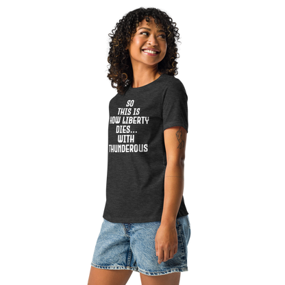 "So this is how liberty dies… with thunderous applause" printed on a dark grey heather women's relaxed t-shirt worn by a female