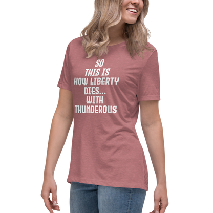 "So this is how liberty dies… with thunderous applause" printed on a heather mauve women's relaxed t-shirt worn by a female