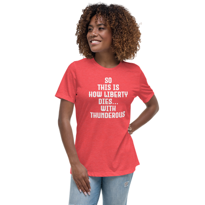 "So this is how liberty dies… with thunderous applause" printed on a heather red women's relaxed t-shirt worn by a female
