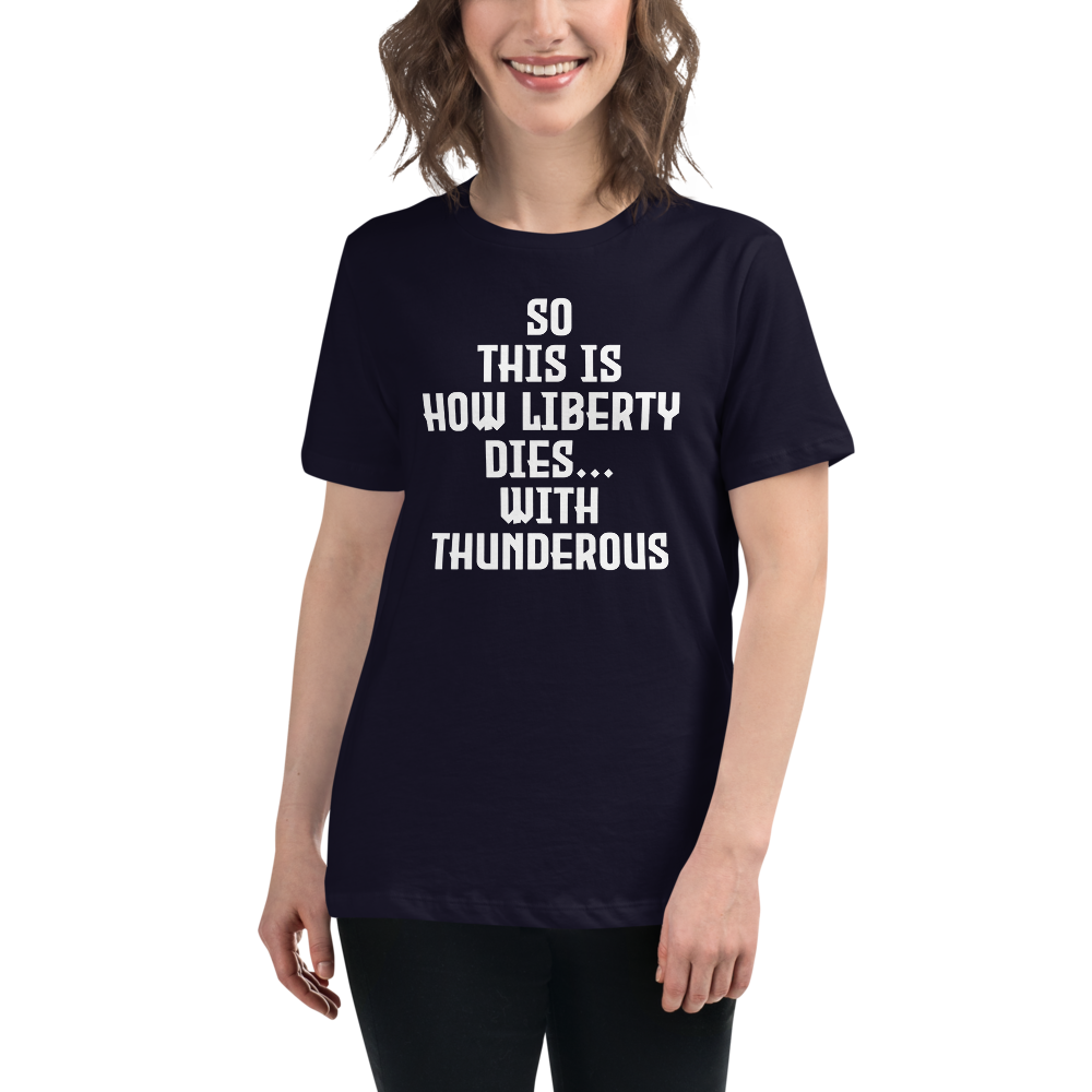 "So this is how liberty dies… with thunderous applause" printed on a navy women's relaxed t-shirt worn by a female
