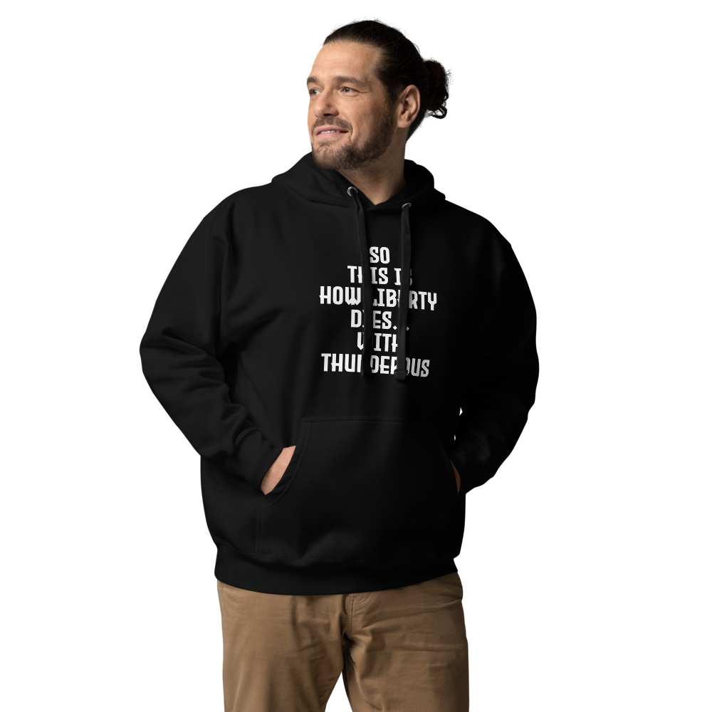 "So this is how liberty dies… with thunderous applause" printed on a black unisex hoodie worn by a male