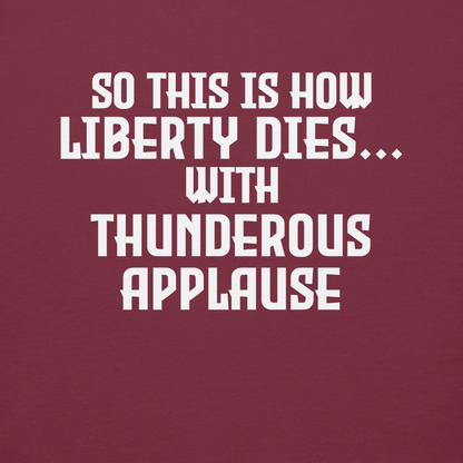 "So this is how liberty dies… with thunderous applause" printed on a maroon background