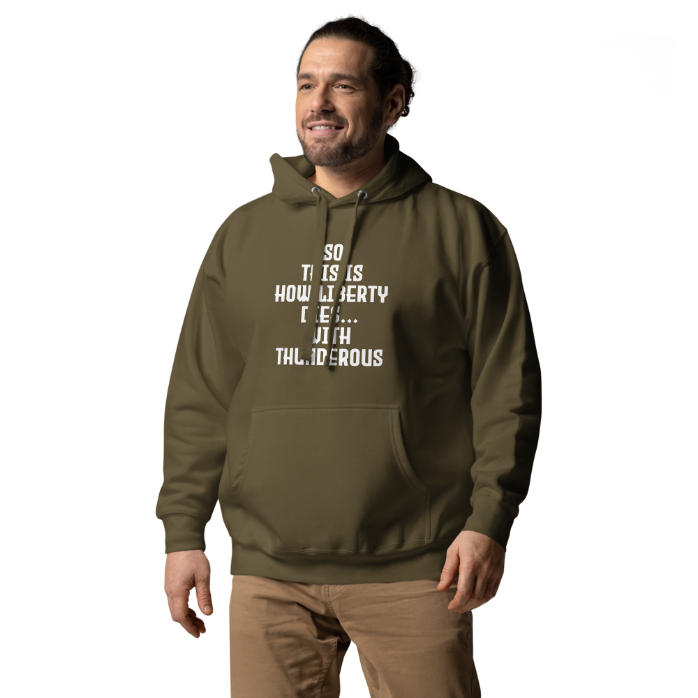 "So this is how liberty dies… with thunderous applause" printed on a military green unisex hoodie worn by a male