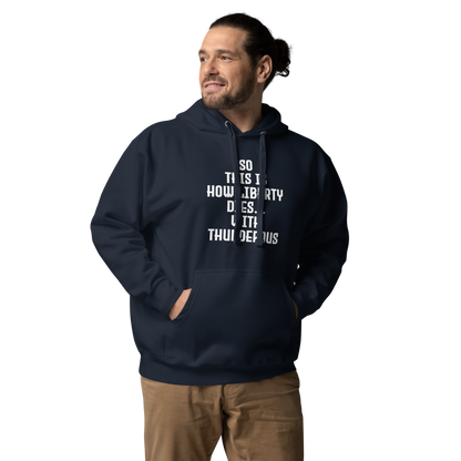 "So this is how liberty dies… with thunderous applause" printed on a navy blazer unisex hoodie worn by a male