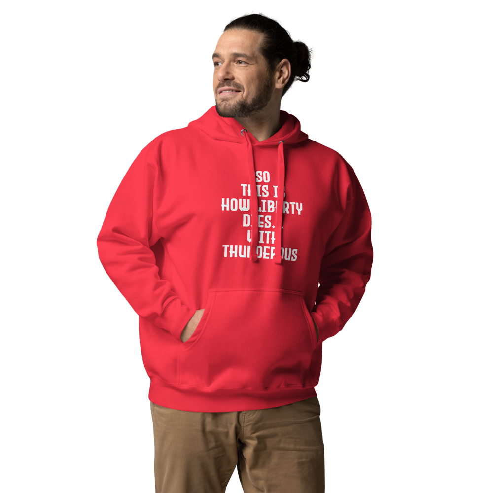 "So this is how liberty dies… with thunderous applause" printed on a team red unisex hoodie worn by a male
