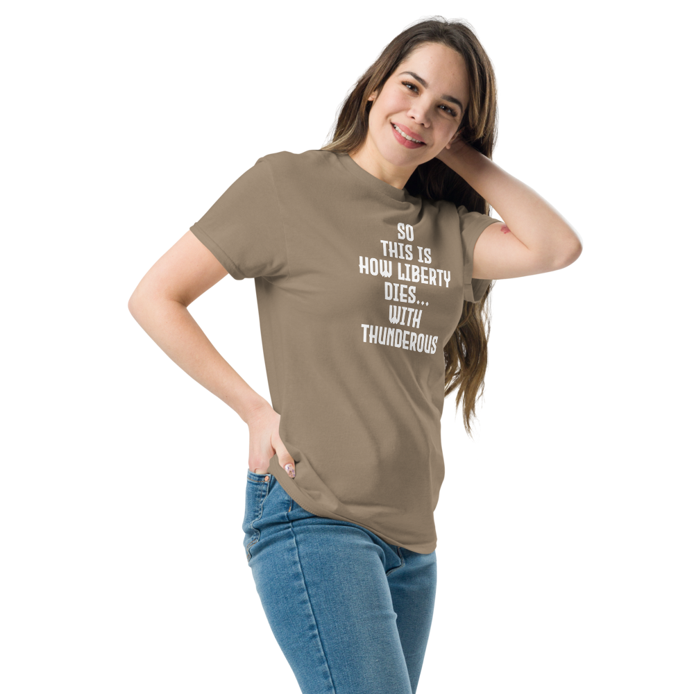"So this is how liberty dies… with thunderous applause" printed on a brown savana unisex classic tee worn by a female