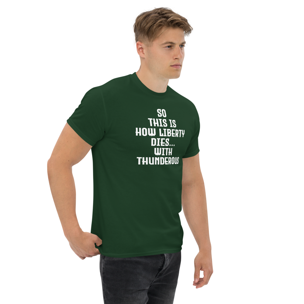 "So this is how liberty dies… with thunderous applause" printed on a forest green unisex classic tee worn by a male