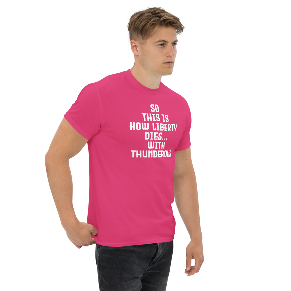 "So this is how liberty dies… with thunderous applause" printed on a heliconia unisex classic tee worn by a male