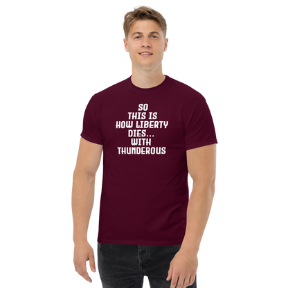 "So this is how liberty dies… with thunderous applause" printed on a maroon unisex classic tee worn by a male