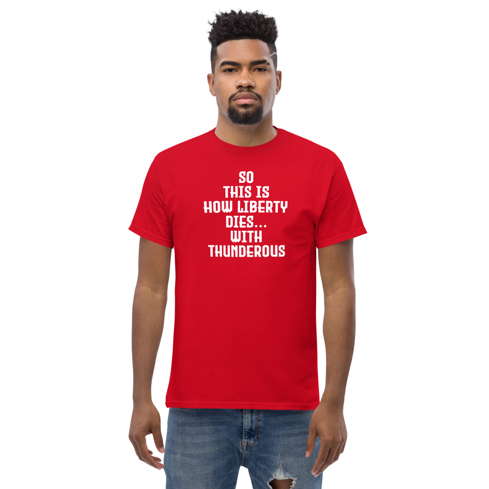 "So this is how liberty dies… with thunderous applause" printed on a red unisex classic tee worn by a male