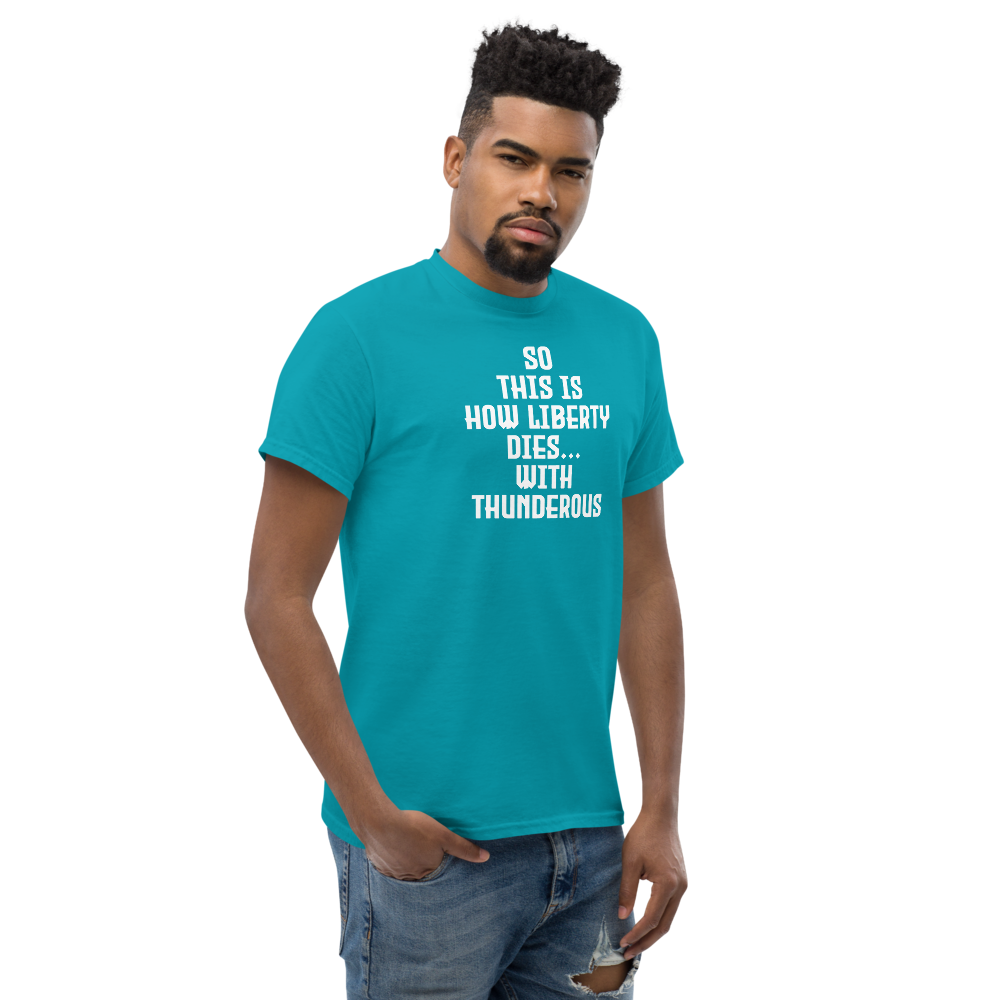 "So this is how liberty dies… with thunderous applause" printed on a tropical blue unisex classic tee worn by a male