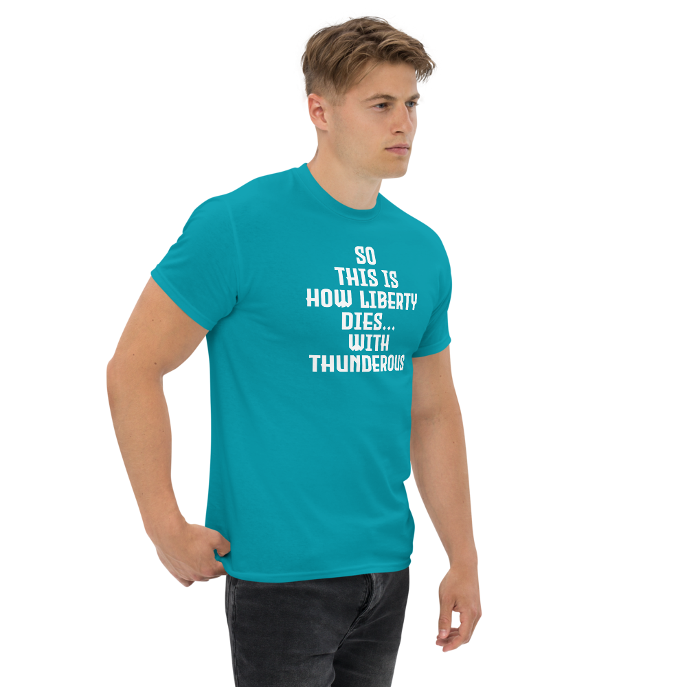 "So this is how liberty dies… with thunderous applause" printed on a tropical blue unisex classic tee worn by a male