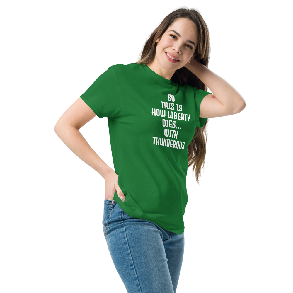 "So this is how liberty dies… with thunderous applause" printed on a turf green unisex classic tee worn by a female