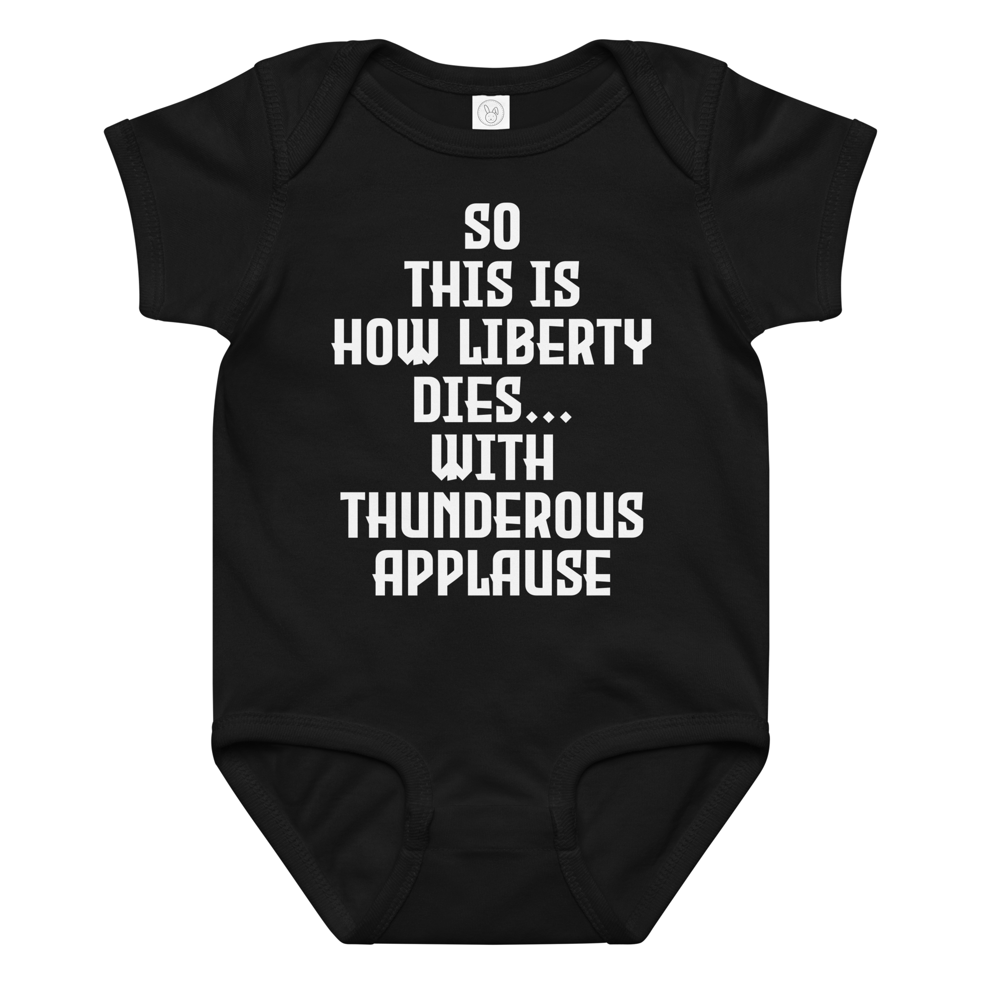 "So this is how liberty dies… with thunderous applause" printed on a black baby jersey bodysuit laying on a flat surface amongst other clothes