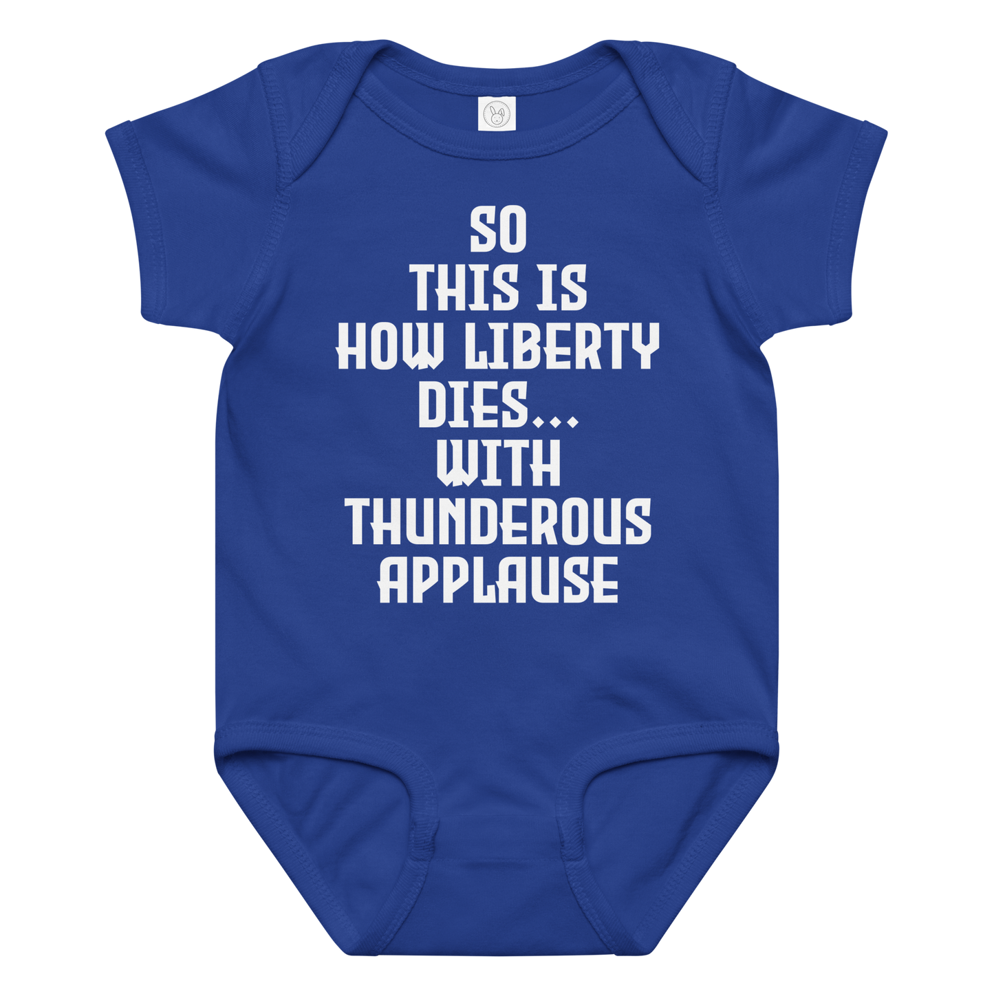 "So this is how liberty dies… with thunderous applause" printed on a royal baby jersey bodysuit laying on a flat surface amongst other clothes
