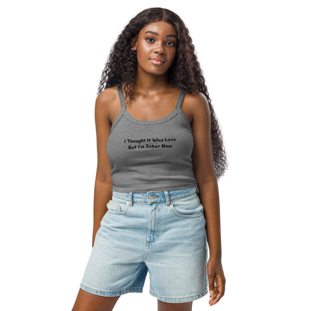 "I thought it was love but I’m sober now" printed on a athletic heather women's micro-rib tanktop worn by a female