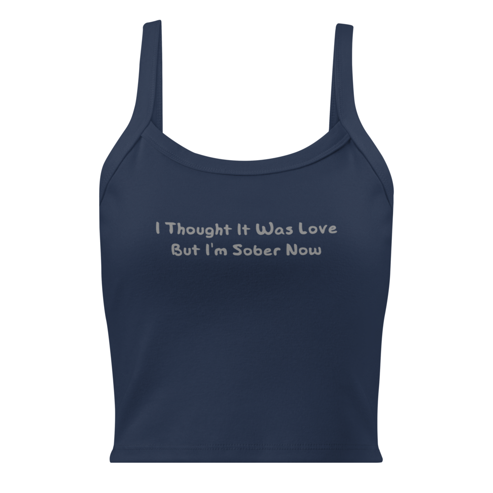"I thought it was love but I’m sober now" printed on a solid navy blend women's micro-rib tanktop laying on a flat surface