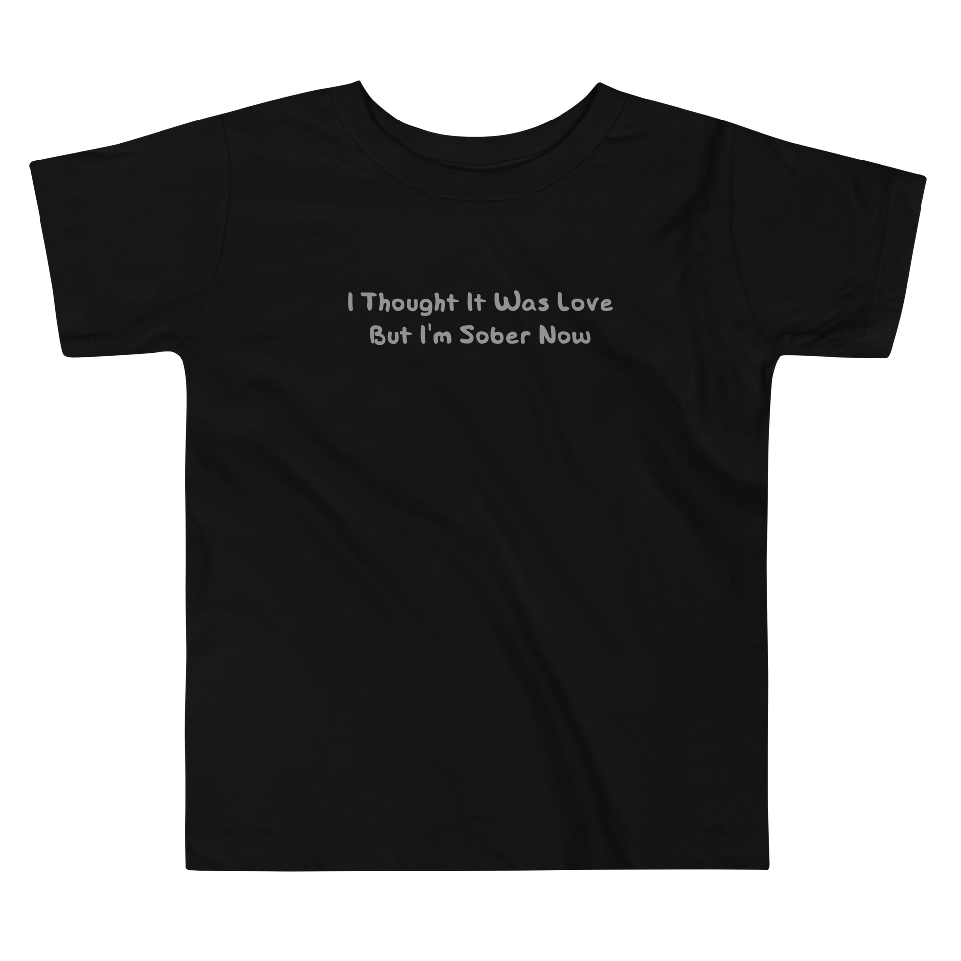 "I thought it was love but I’m sober now" printed on a black toddler short sleeve tee laying on a flat surface