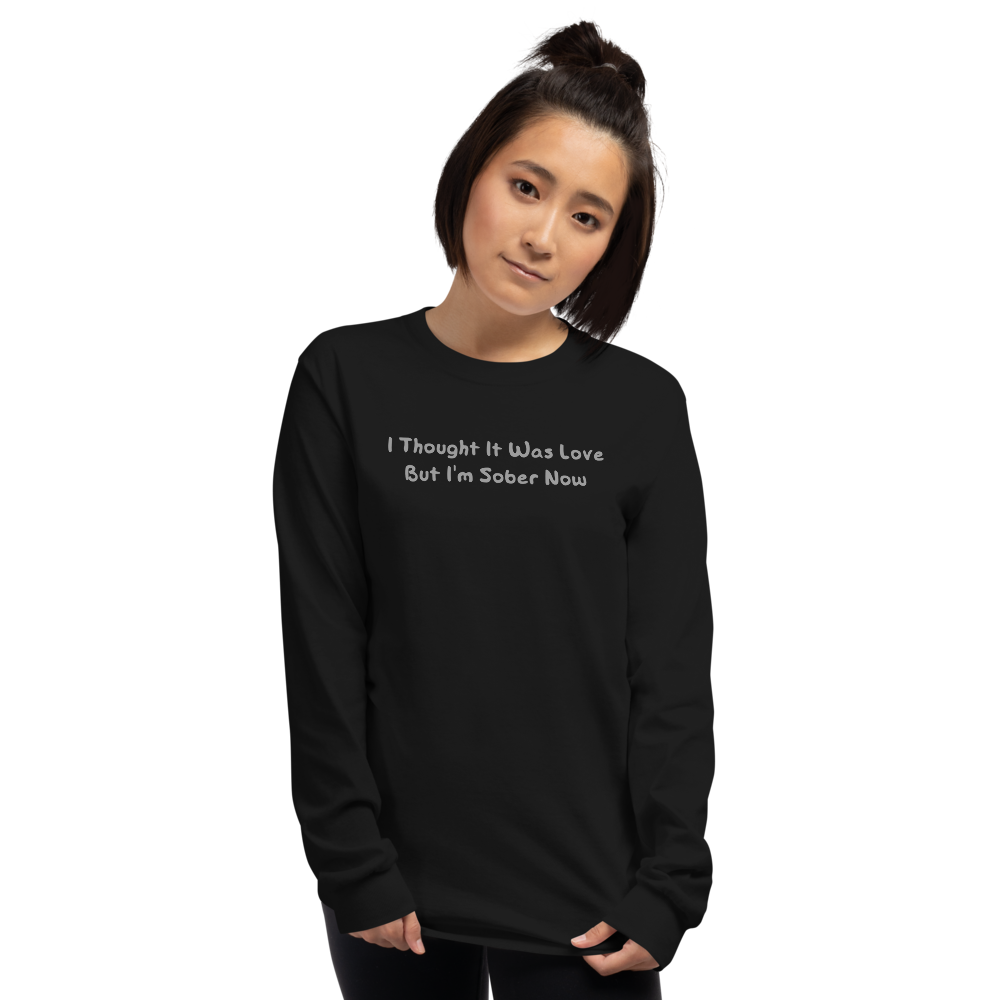 "I thought it was love but I’m sober now" printed on a black men's long sleeve shirt worn by a female