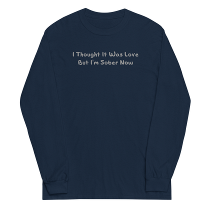 "I thought it was love but I’m sober now" printed on a navy men's long sleeve shirt laying on a flat surface