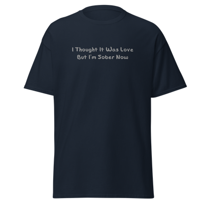 "I thought it was love but I’m sober now" printed on a navy on an invisible body