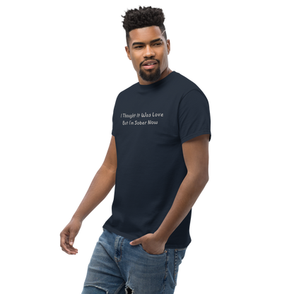 "I thought it was love but I’m sober now" printed on a navy unisex classic tee worn by a male