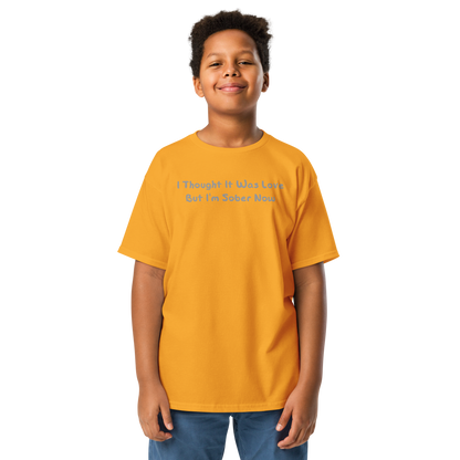 "I thought it was love but I’m sober now" printed on a gold youth classic tee worn by a male