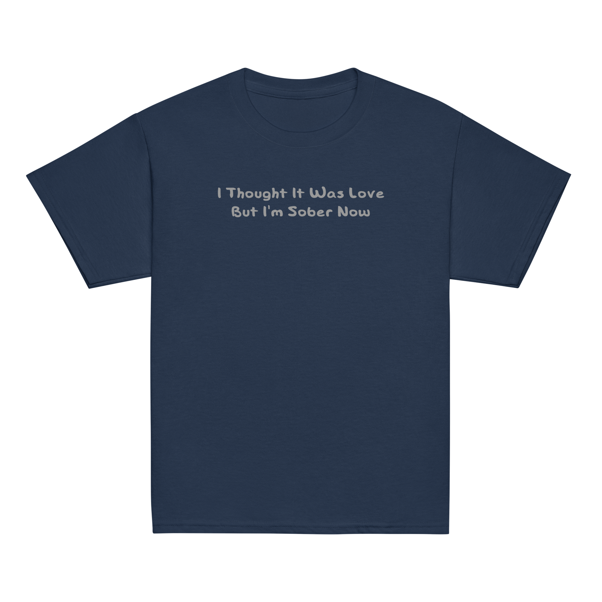 "I thought it was love but I’m sober now" printed on a navy youth classic tee laying on a flat surface