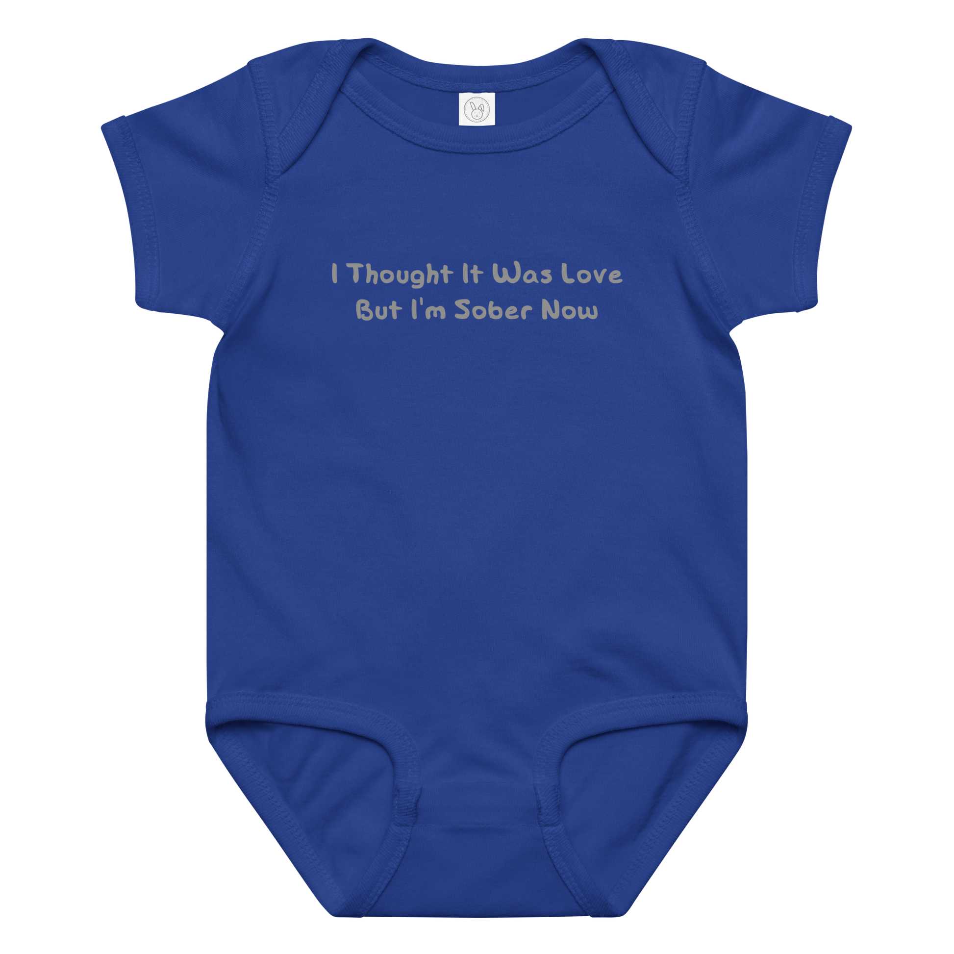 "I thought it was love but I’m sober now" printed on a royal baby jersey bodysuit laying on a flat surface amongst other clothes