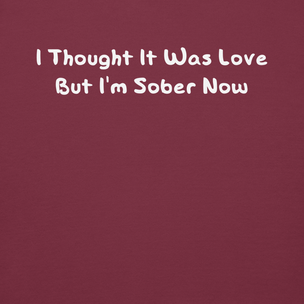"I thought it was love but I’m sober now" printed on a maroon background