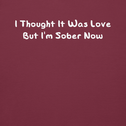 "I thought it was love but I’m sober now" printed on a maroon background